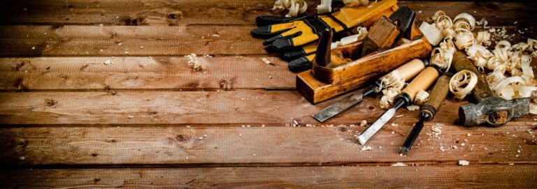 Working tool on wood with sawdust.